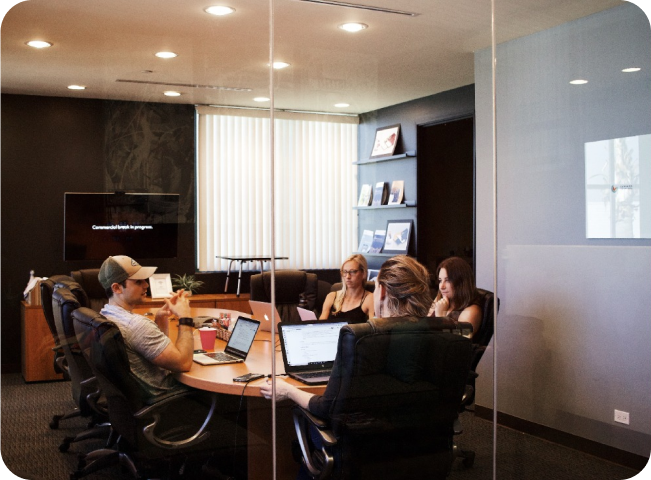 employees on a meeting inside a glass room