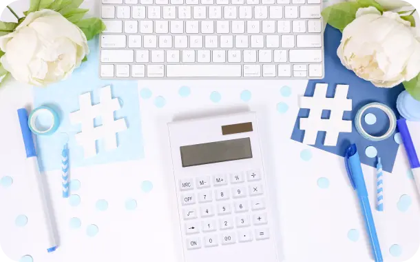 top view of a keyboard, pens and calculator set on table